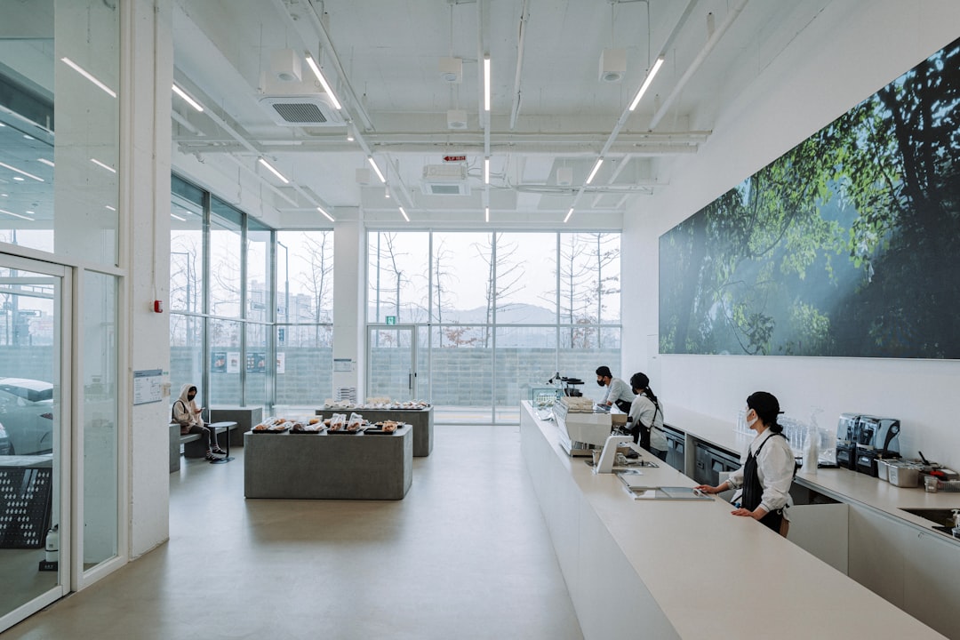 a-group-of-people-sitting-at-desks-in-an-office-j-qqhla-wmg