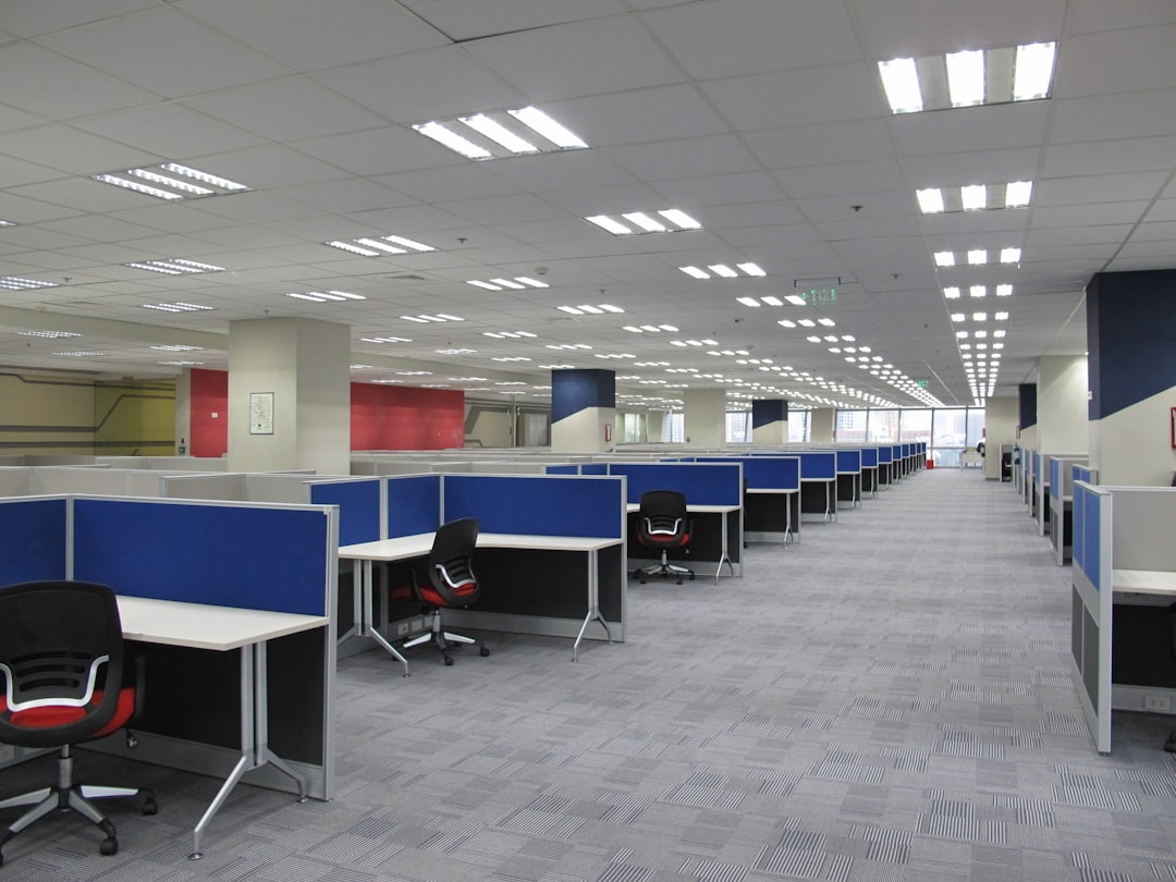 an-empty-office-cubicle-with-chairs-and-desks-c-nsmp-z1xk